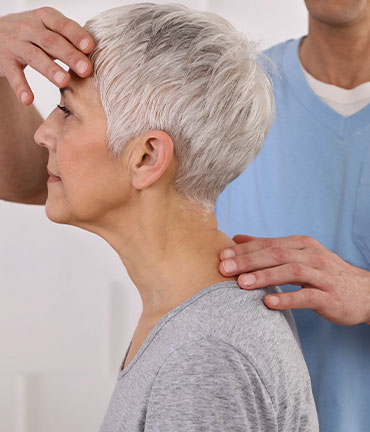 Patient receiving chiropractic adjusmtent for migraine relief from Roseville Chiropractors
